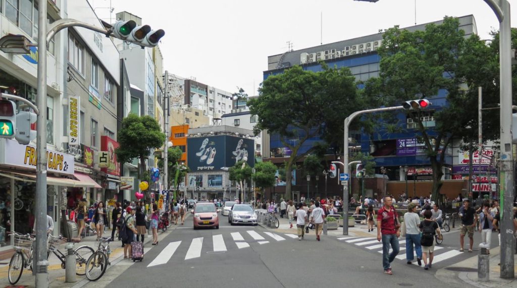 Street crossing lined with shops in Amerikamura, Osaka's youth fashion district