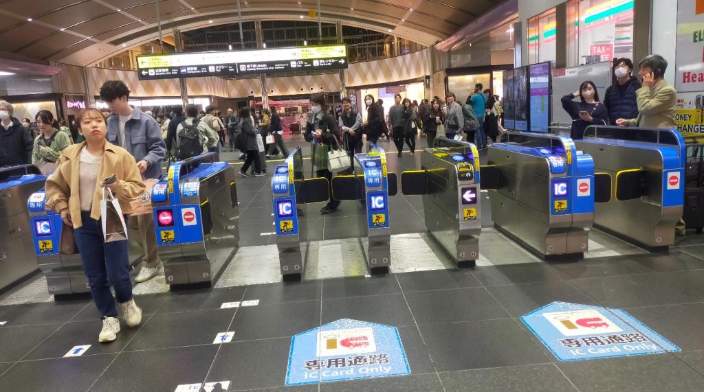 Travelers passing through IC card ticket gates at Kyoto Station