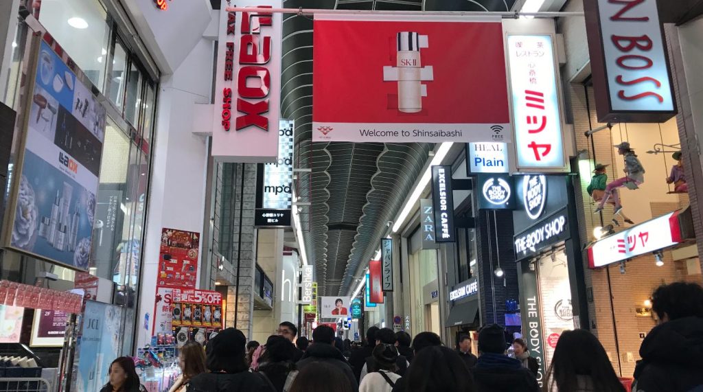 Shoppers walking through the covered Shinsaibashi-suji arcade in Osaka